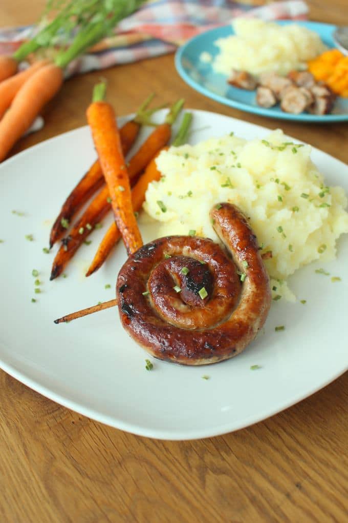 Bratwurst mit Parmesan-Kartoffelstampf und karamellisierten Möhren