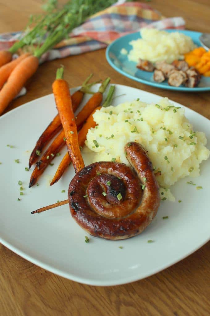 Bratwurst mit Parmesan-Kartoffelstampf und karamellisierten Möhren